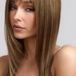 Long, straight, light brown wig with side-swept bangs on a model.